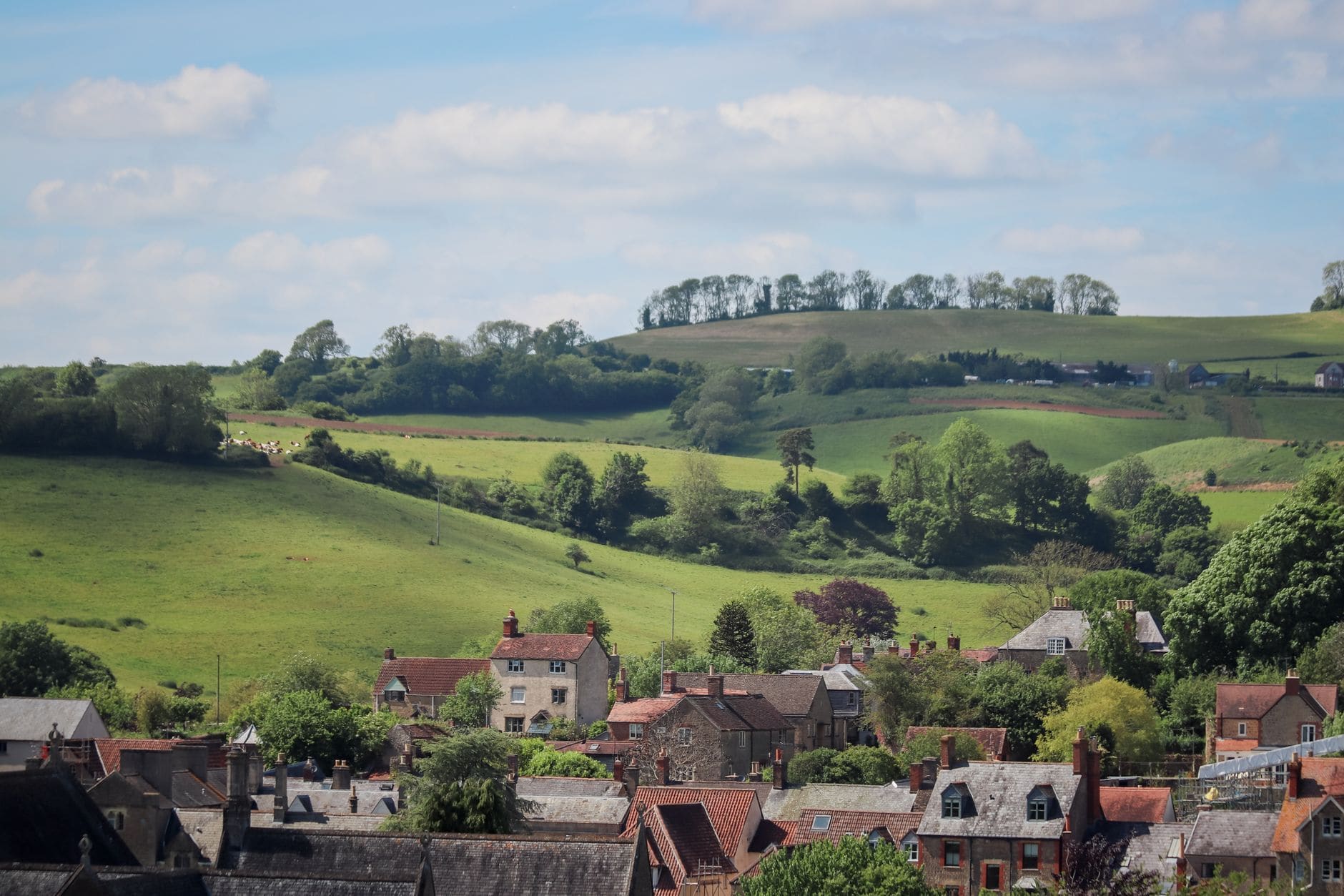 Rolling hills above a village of stone houses