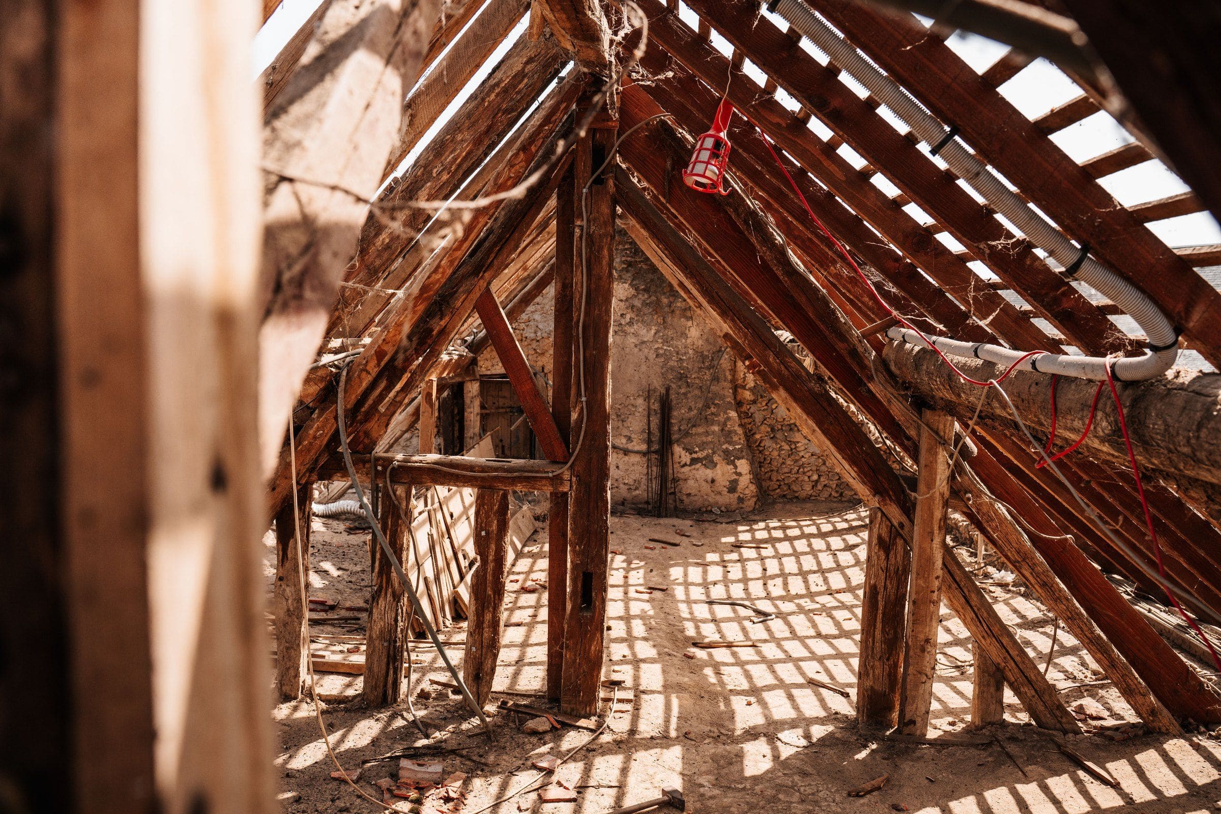 Bare rafters and battens in a roof stripped of its tiles